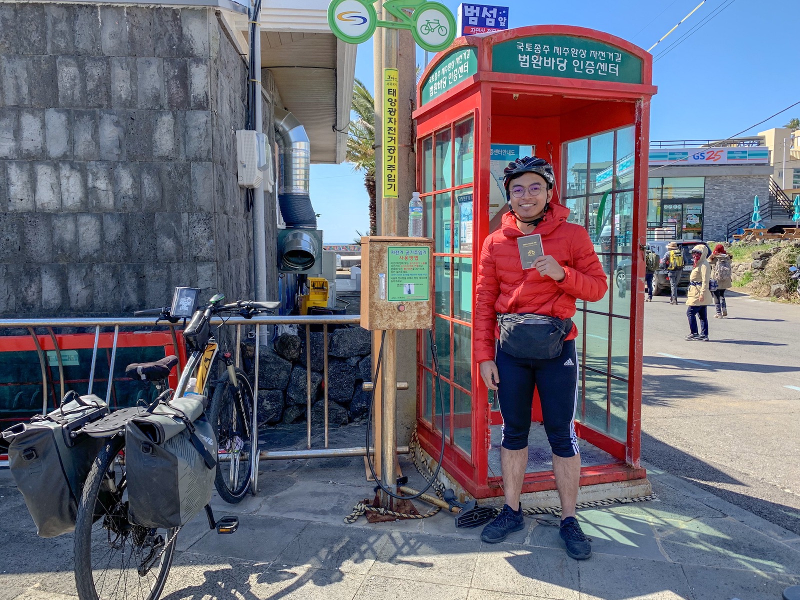 A picture of me holding Jeju Bike Passport